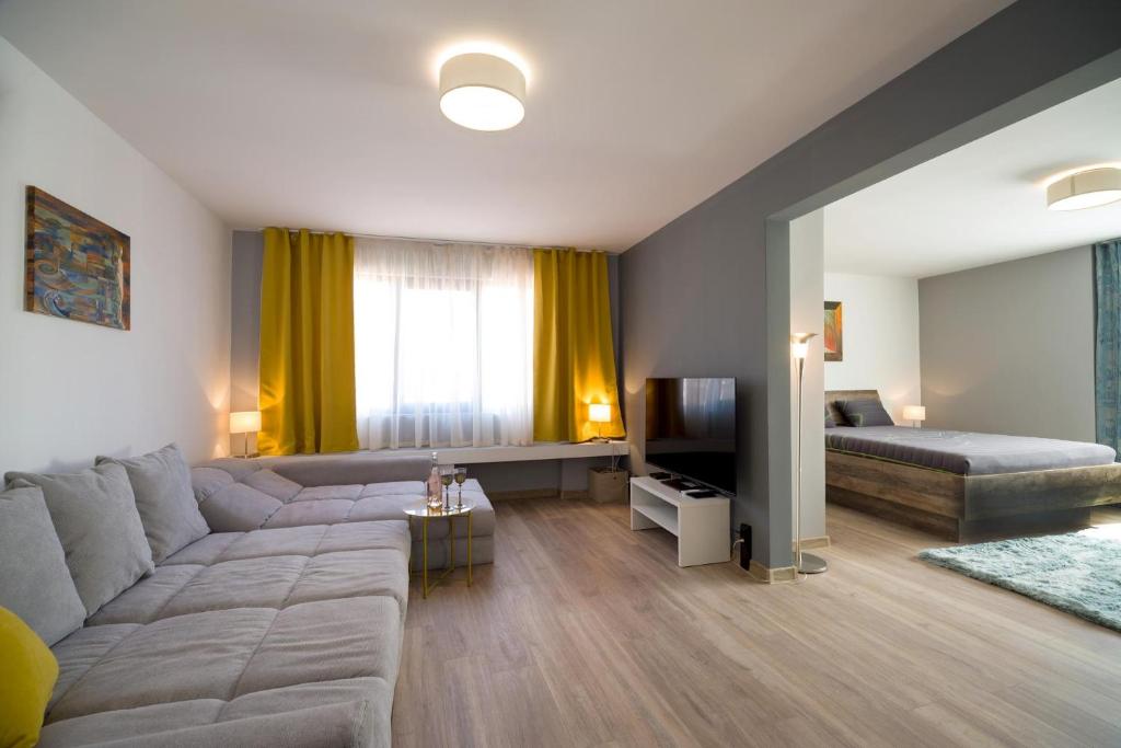 ein Wohnzimmer mit einem Sofa und einem Bett in der Unterkunft Luxury & Calm Apartment in Burgas City
