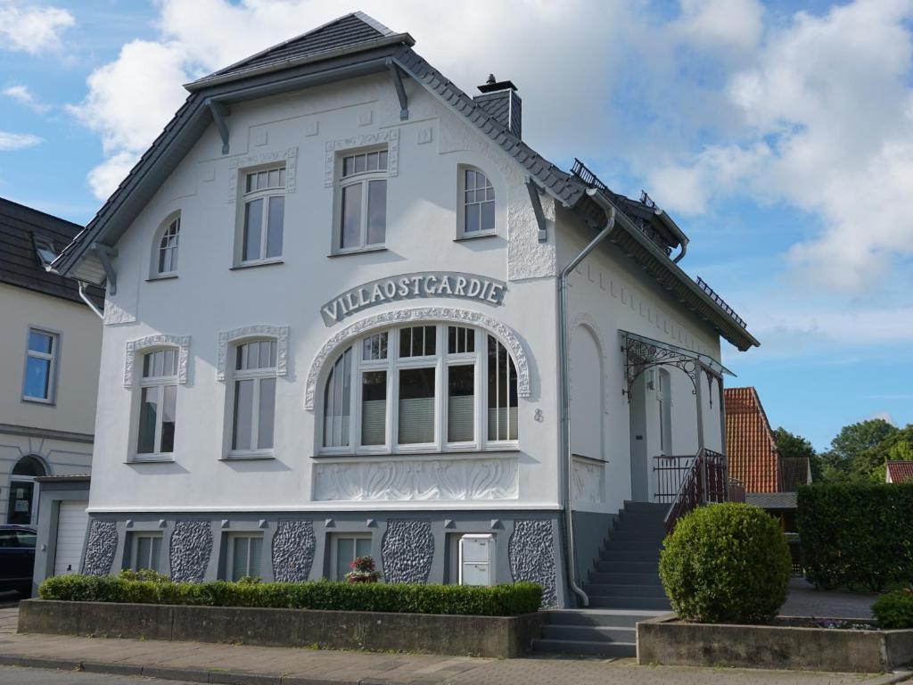 a white building with a sign on it at Villa Ostgardie in Schleswig