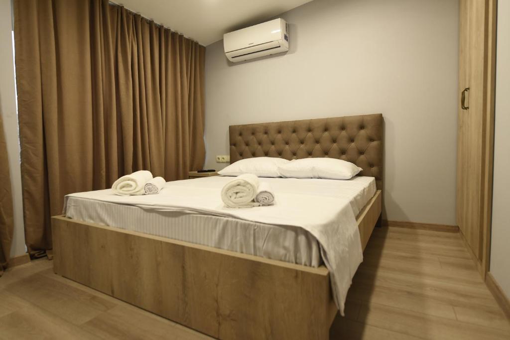 a bedroom with a large bed with towels on it at Family Hotel Avlabar in Tbilisi City