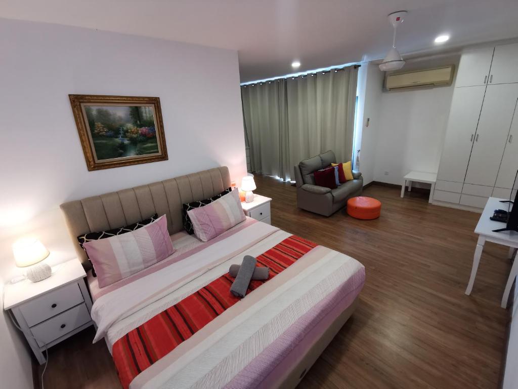 a bedroom with a large bed and a living room at Apple 4@Menara Simfoni/King Bed/Wifi/Netflix/TVBOX in Cheras