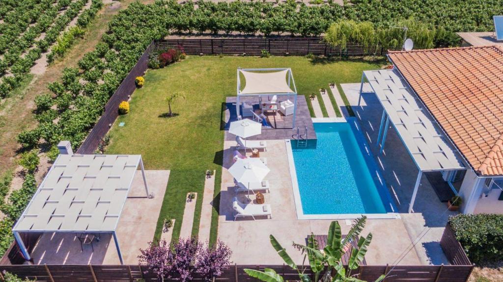an aerial view of a backyard with a swimming pool at Madini Luxury villa with private heated pool in Vanáton