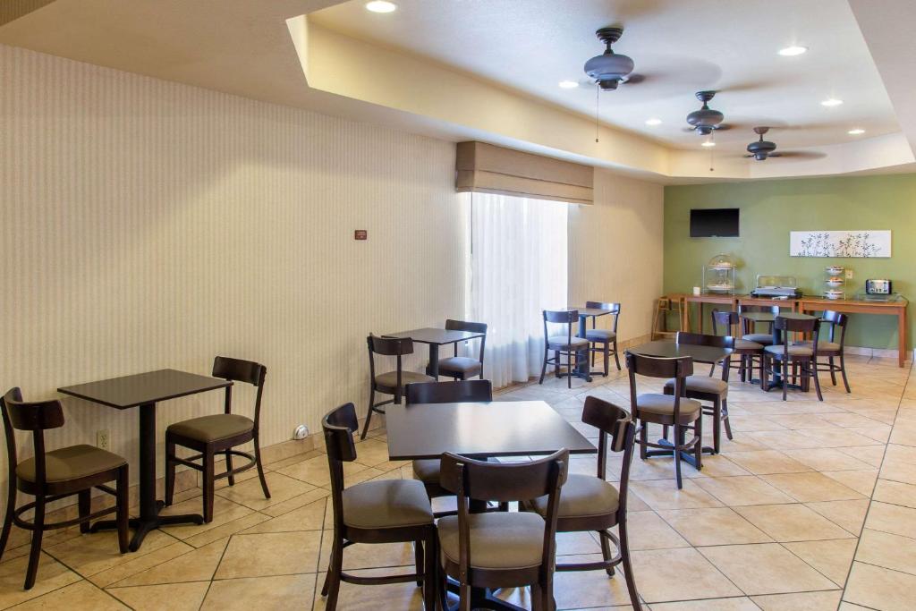 ein Restaurant mit Tischen und Stühlen in einem Raum in der Unterkunft Sleep Inn &amp; Suites Bakersfield North in Bakersfield
