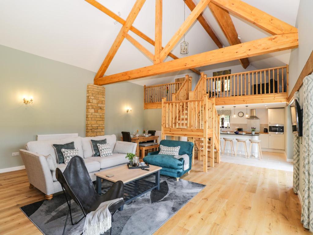 a living room with a couch and a table at Petals Patch in Cheltenham