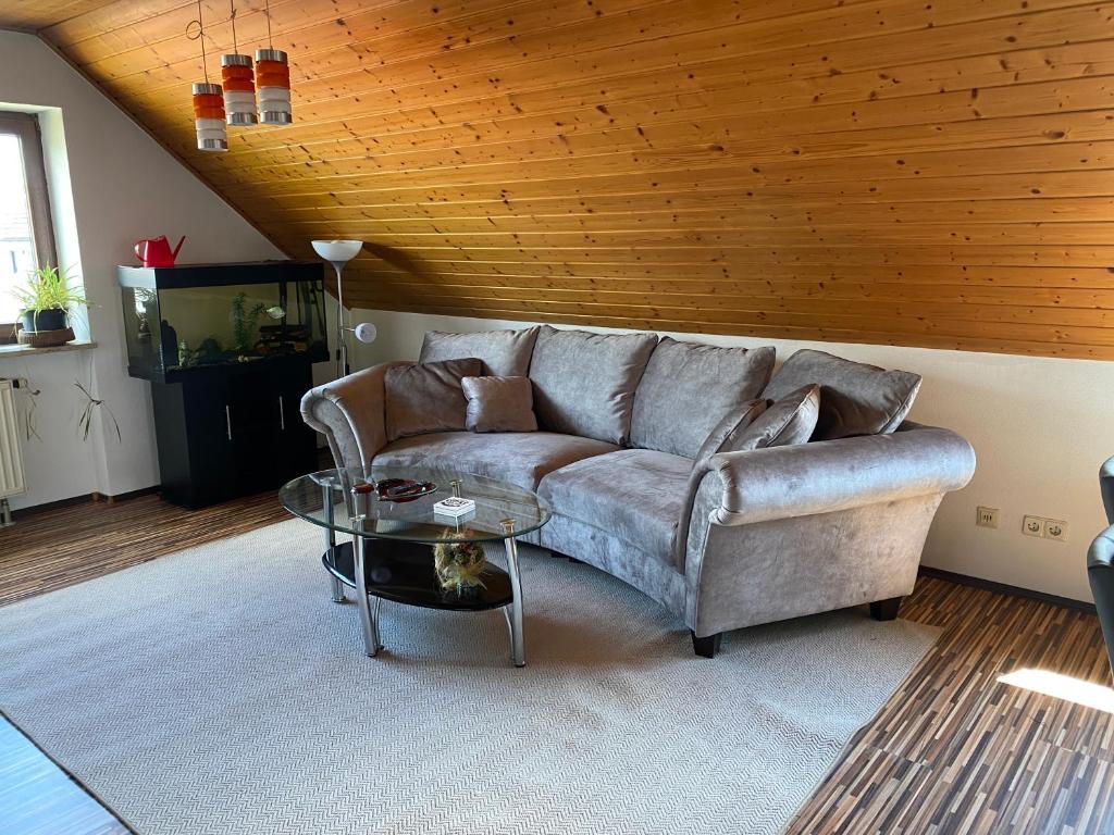ein Wohnzimmer mit einem Sofa und einem Tisch in der Unterkunft Villa Ulla in Burgoberbach
