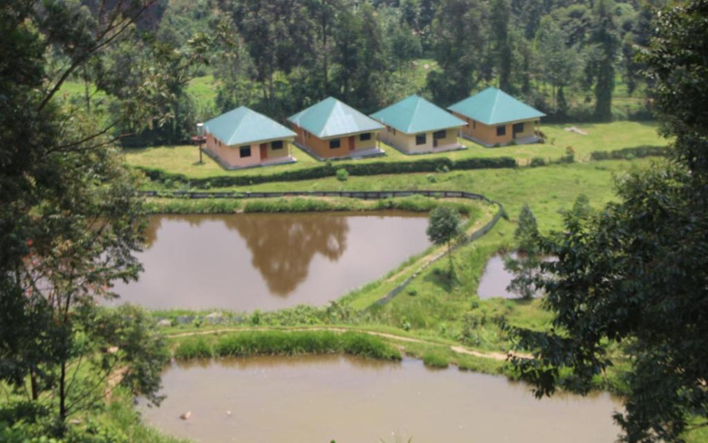 an aerial view of a resort with two ponds at Snow Valley Cottages in Kasese