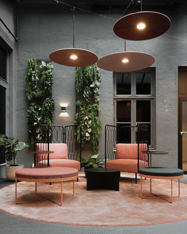 two chairs and a table in front of a building at Citybox Oslo in Oslo