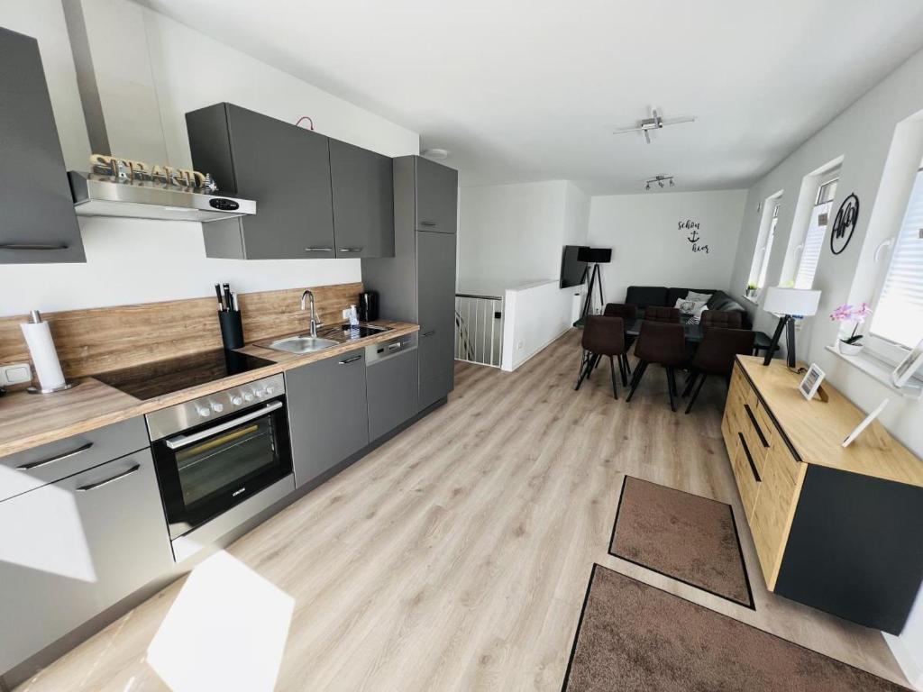 a kitchen and a living room with a dining room at OceanHome in Scharbeutz