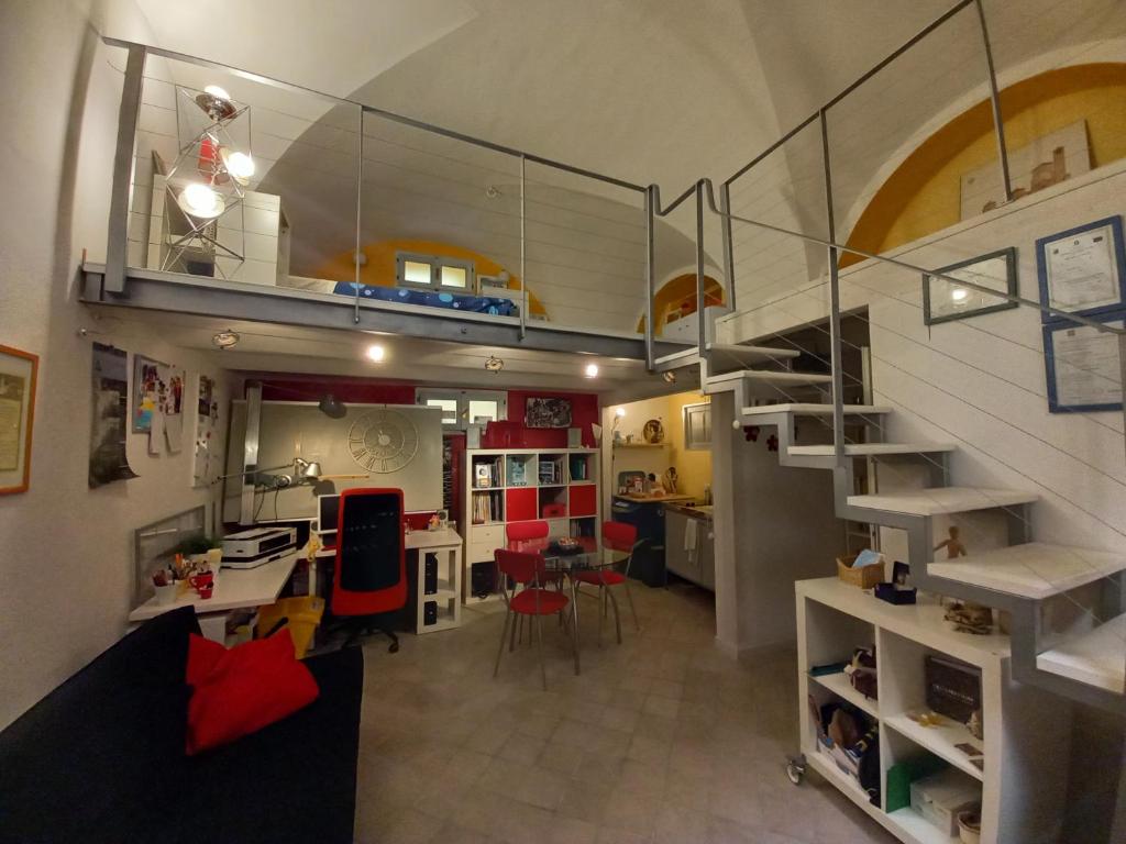 a living room and kitchen with a staircase in a house at Ars Amandi in Sulmona