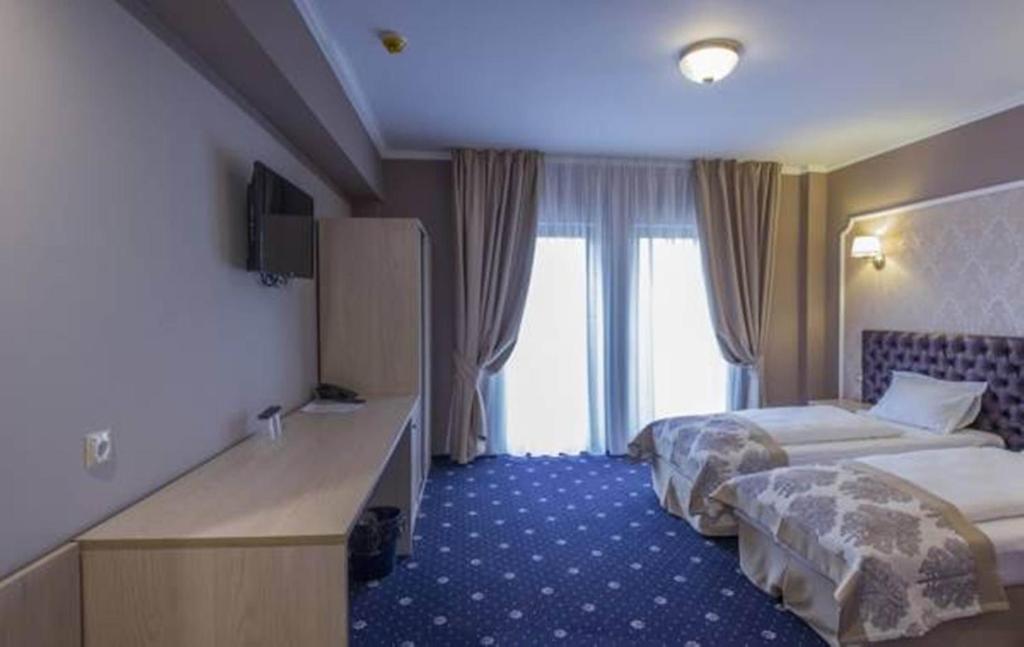 Postel nebo postele na pokoji v ubytování Hotel Bulevard