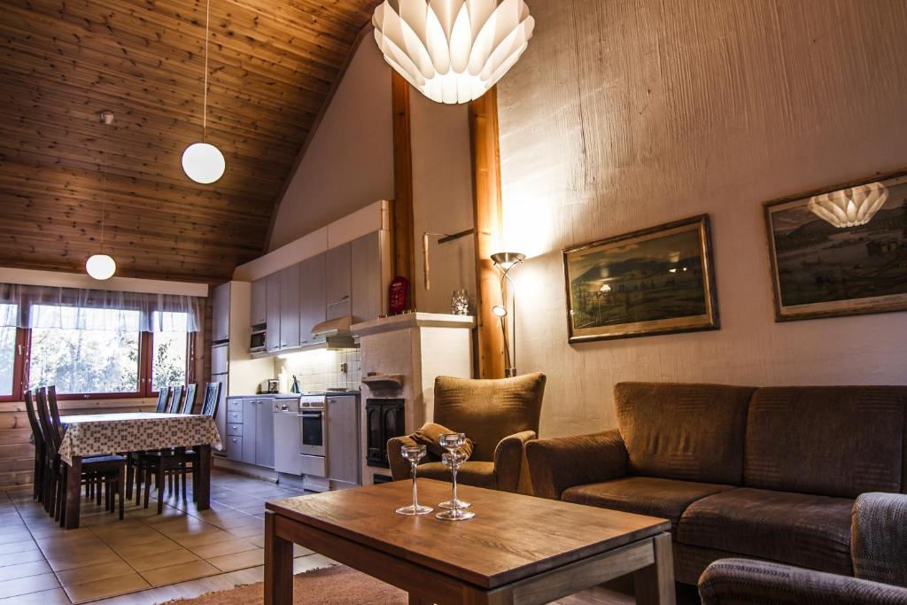 a living room with a couch and a table at Lomakulkuri Apartments in Vuokatti