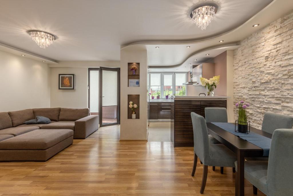 a living room with a couch and a table at Jekabpils 2 Apartment in Rīga