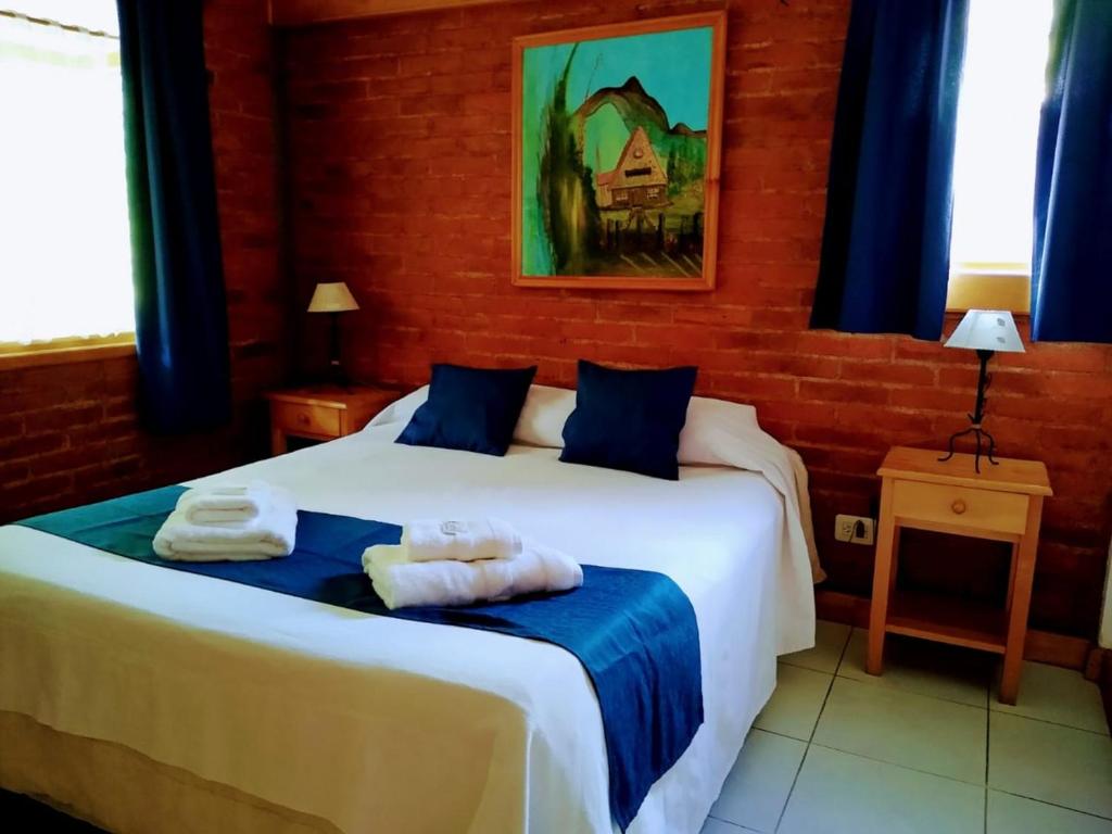 Postel nebo postele na pokoji v ubytování Apart Hotel del Pellin