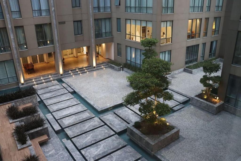 an aerial view of a building with a courtyard at Living Sensory 1-bed rental apartment unit with Pool in Lahore