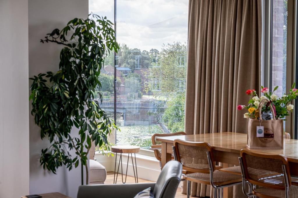 a dining room with a table and a large window at Apartment 304 @ Ryedale House in York
