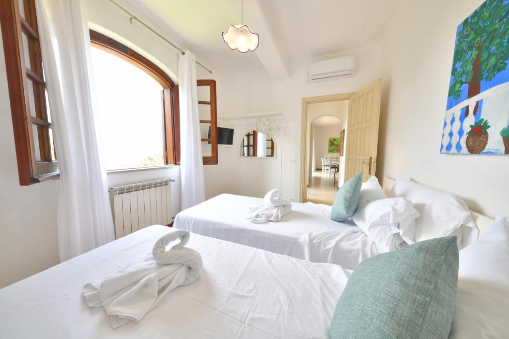 Postel nebo postele na pokoji v ubytování Villa Marecoco