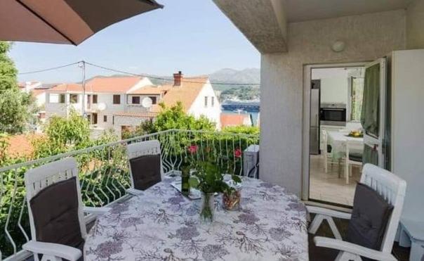 a dining table and chairs on a balcony at Apartment Veve in Dubrovnik
