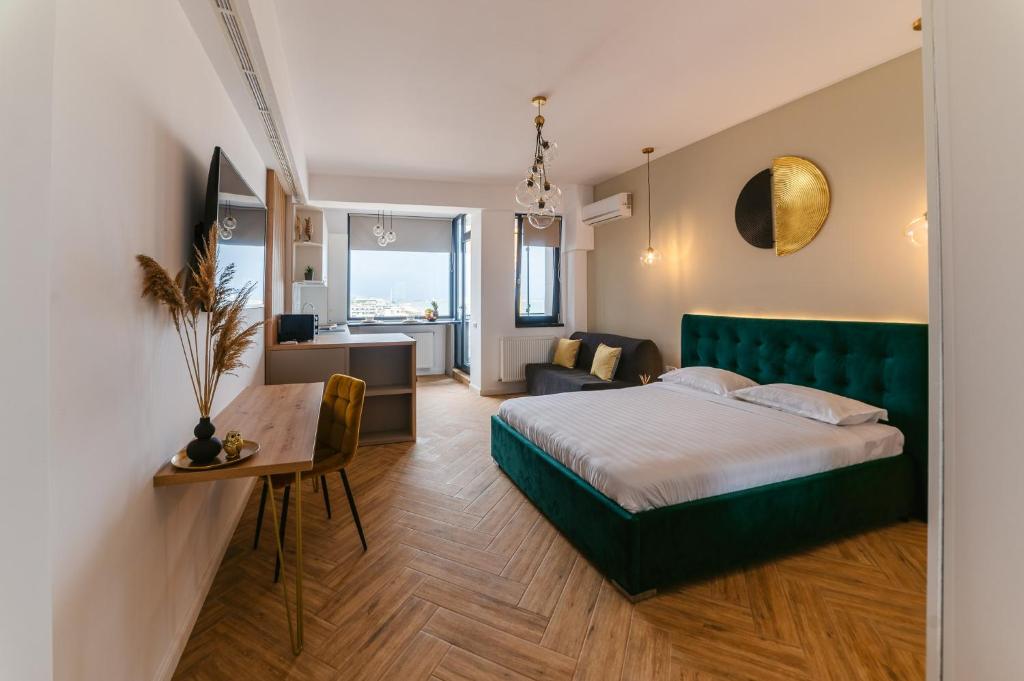 a bedroom with a bed and a desk in a room at SOLMAR Studio Sea View in Năvodari