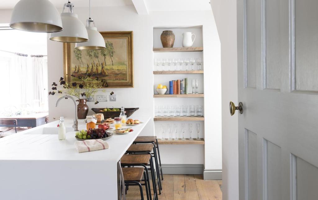 a kitchen with a large white island with bar stools at Pet-friendly Luxury Home For Families & Friends in Brighton & Hove
