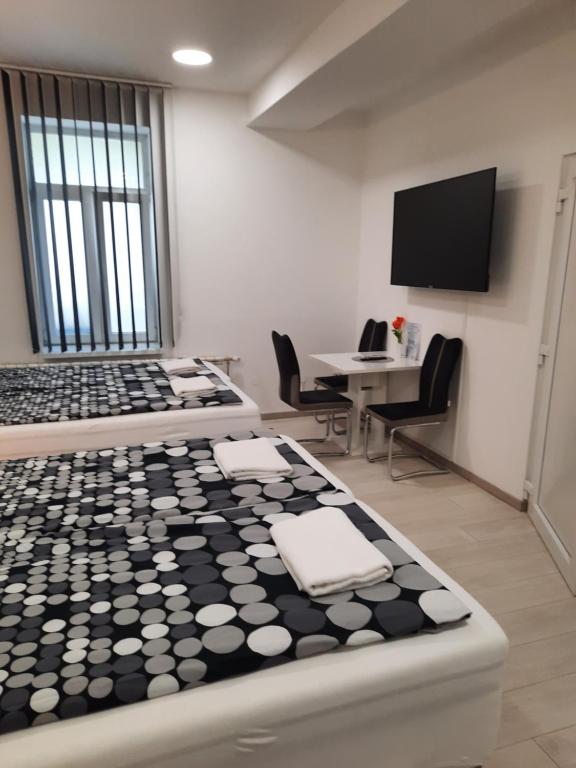 a room with a table and chairs and a tv at Apartments Petrova170 in Zagreb