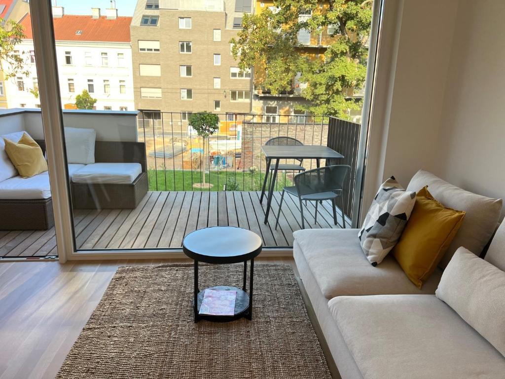 sala de estar con sofá y mesa en el balcón en Terrace Flair, en Viena