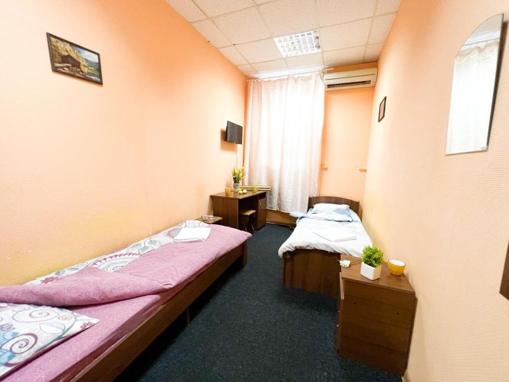 Postel nebo postele na pokoji v ubytování Mini Hotel near Arena City