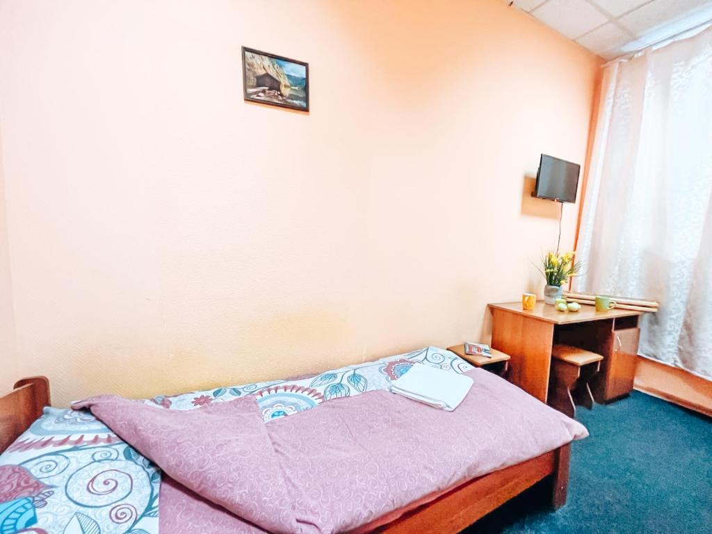 Postel nebo postele na pokoji v ubytování Mini Hotel near Arena City