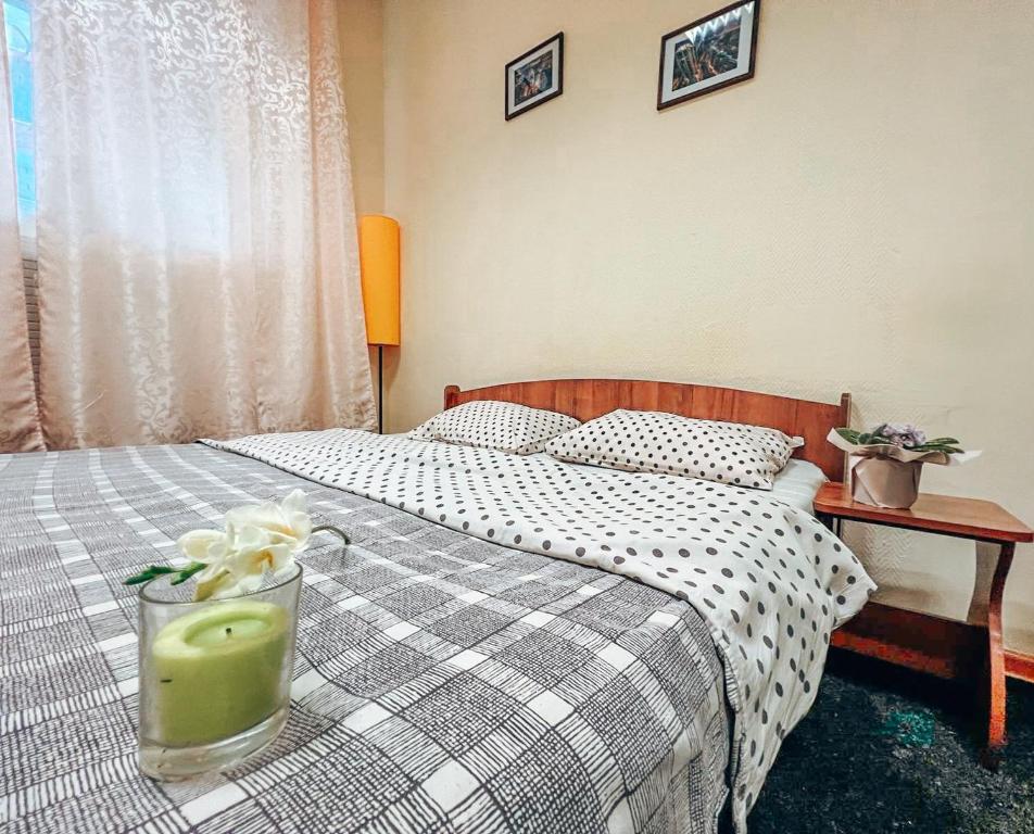 a bedroom with a bed with a candle on it at Mini Hotel near Arena City in Kyiv