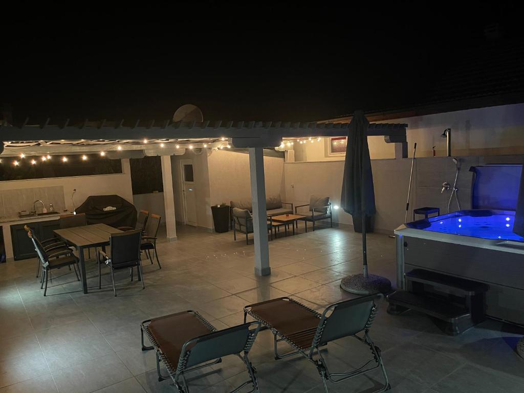 a living room with a pool table and chairs and a pool tablektop at Vila Pedinka in Vir