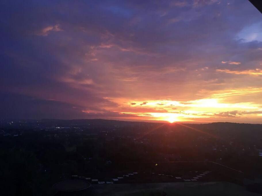 una puesta de sol sobre una ciudad con el sol en el cielo en Views for Africa, en Johannesburgo