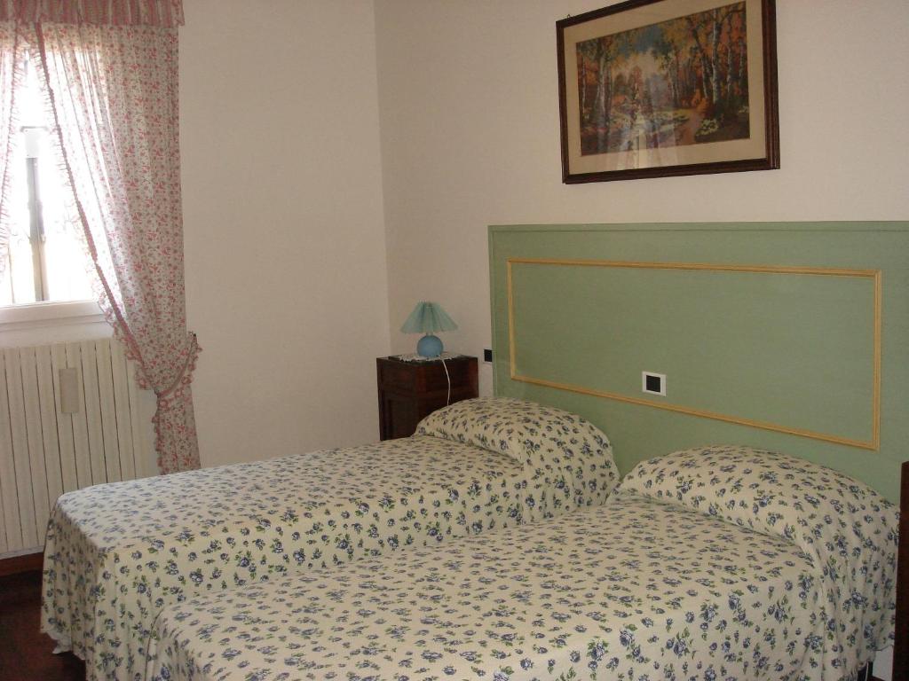 En eller flere senge i et værelse på La Corte Del Cavaliere Bed & Breakfast