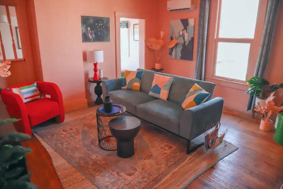 a living room with a couch and a red chair at Casa Mina #4 Central Rio Grande Historic District in El Paso