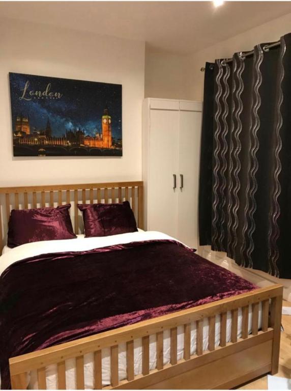 a bedroom with a large bed with purple pillows at Cambridge City Mill in Cambridge