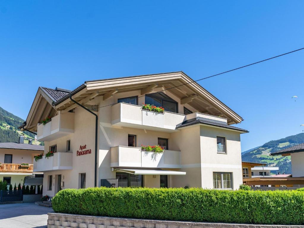 a building with white balconies and plants at Panorama I in Mayrhofen