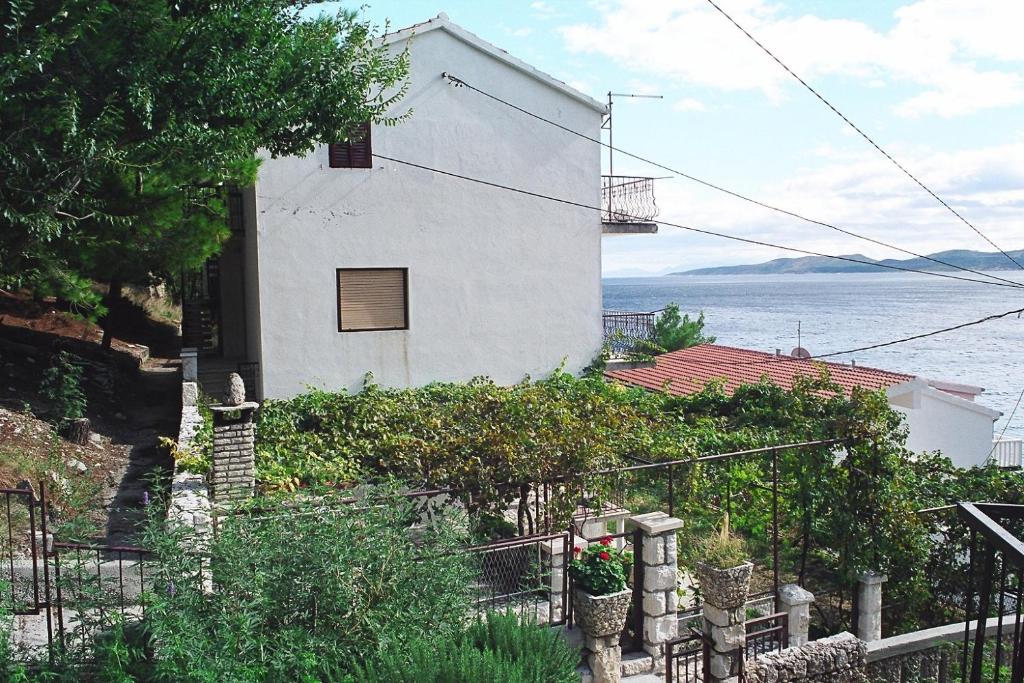 a white house with a view of the water at Apartments by the sea Mimice, Omis - 656 in Mimice