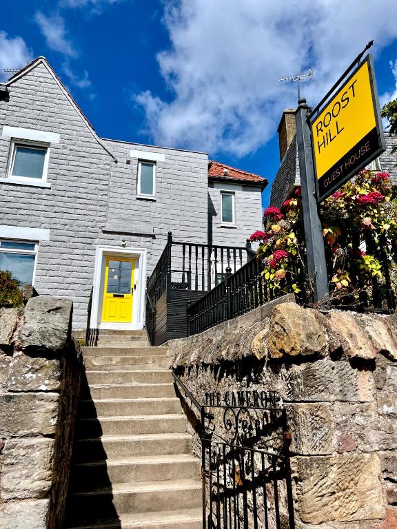 Hotel Roost Hill - Free Parking Zone, a house with a yellow door and a street sign at Roost Hill - Free Parking Zone in Edinburgh