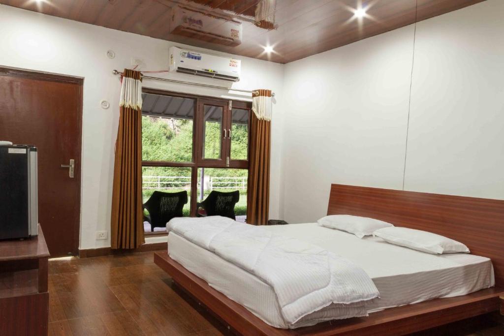 a bedroom with a large bed and a window at SB Mount Resort in Lansdowne