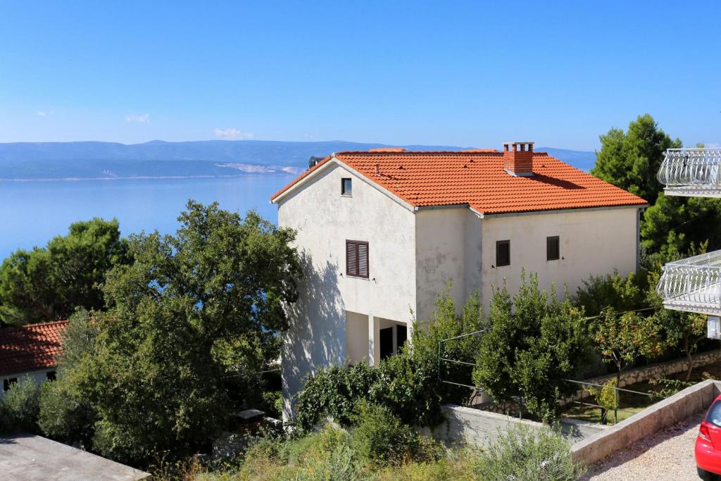 a house with a view of the water at Apartments with a parking space Marusici, Omis - 1041 in Mimice