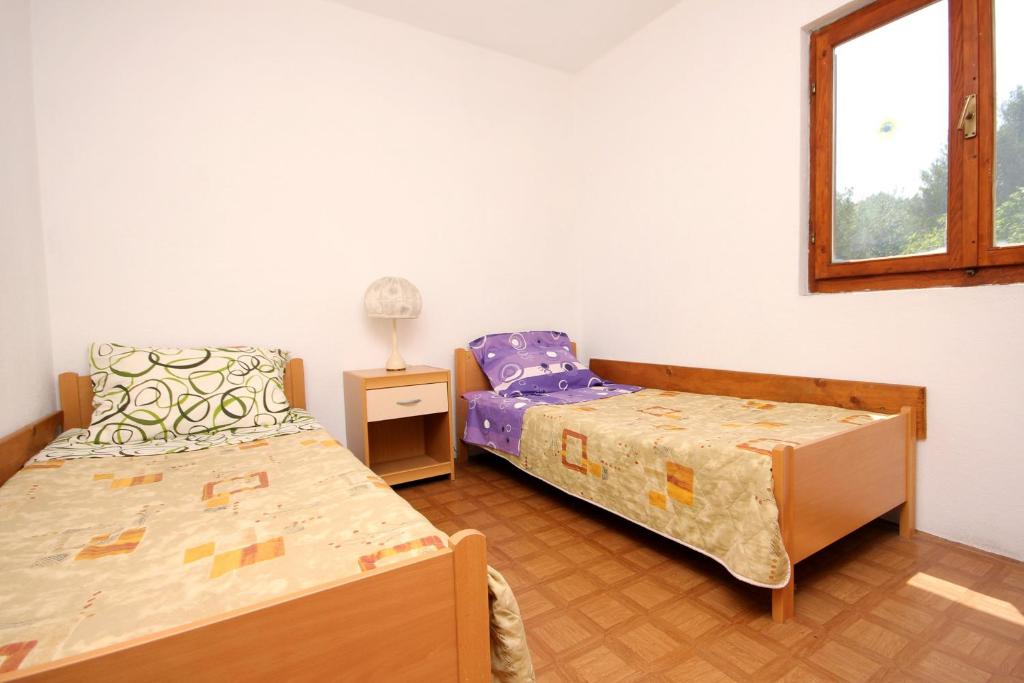 Postel nebo postele na pokoji v ubytování Apartments with WiFi Zman, Dugi otok - 887