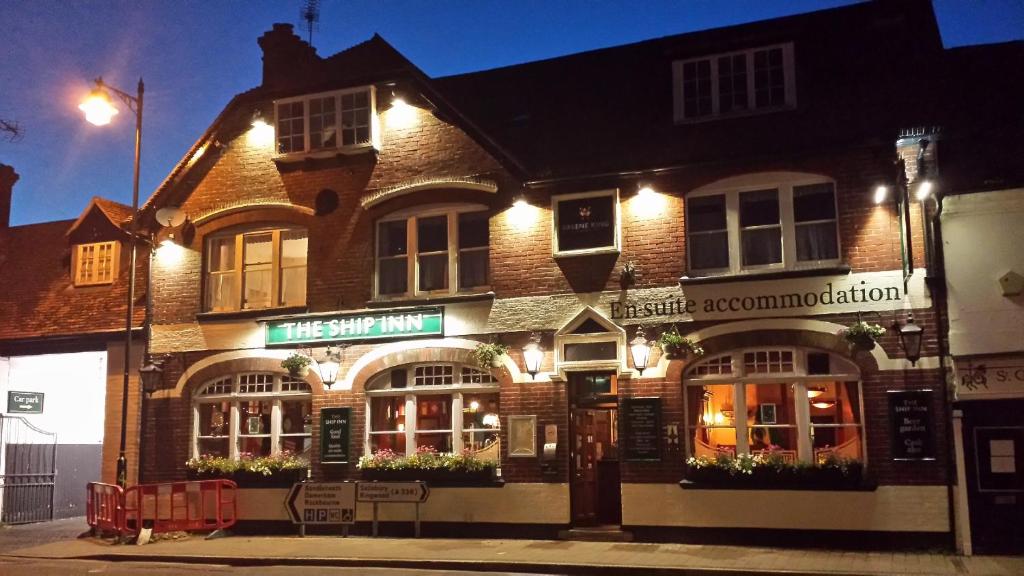 a building on the corner of a street at night at The Ship Inn in Fordingbridge