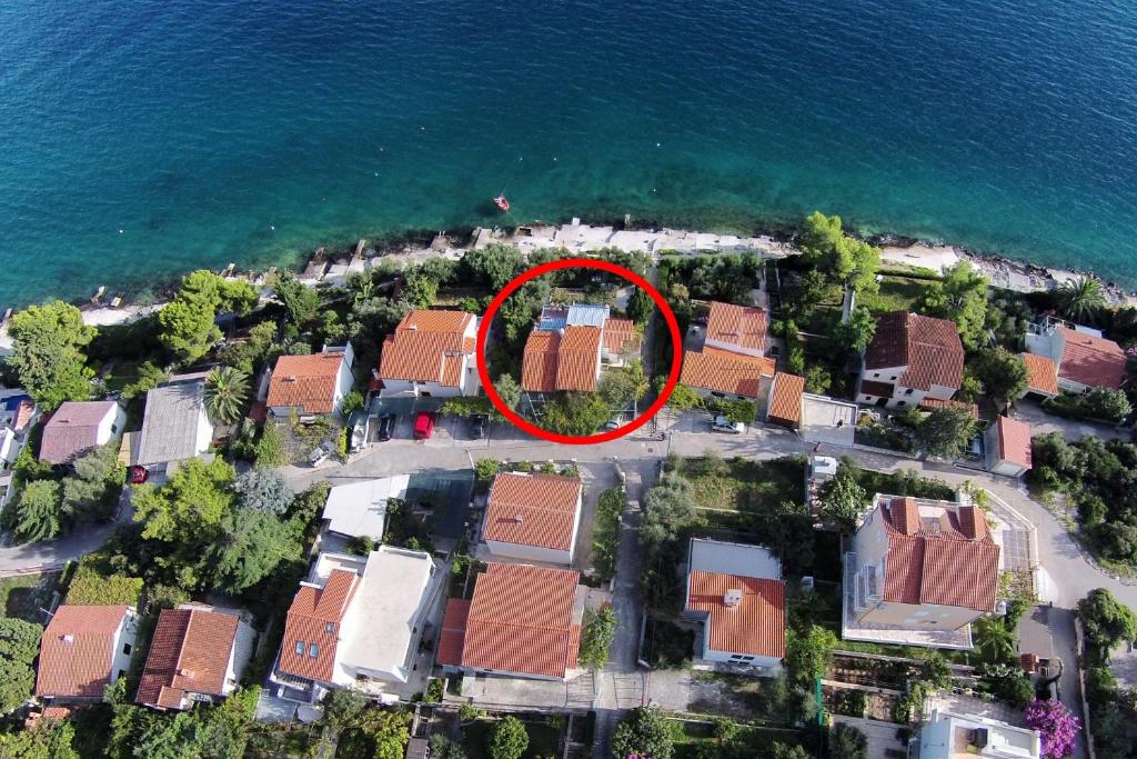 an aerial view of a house near the water at Apartment Seget Vranjica 1051b in Seget Vranjica