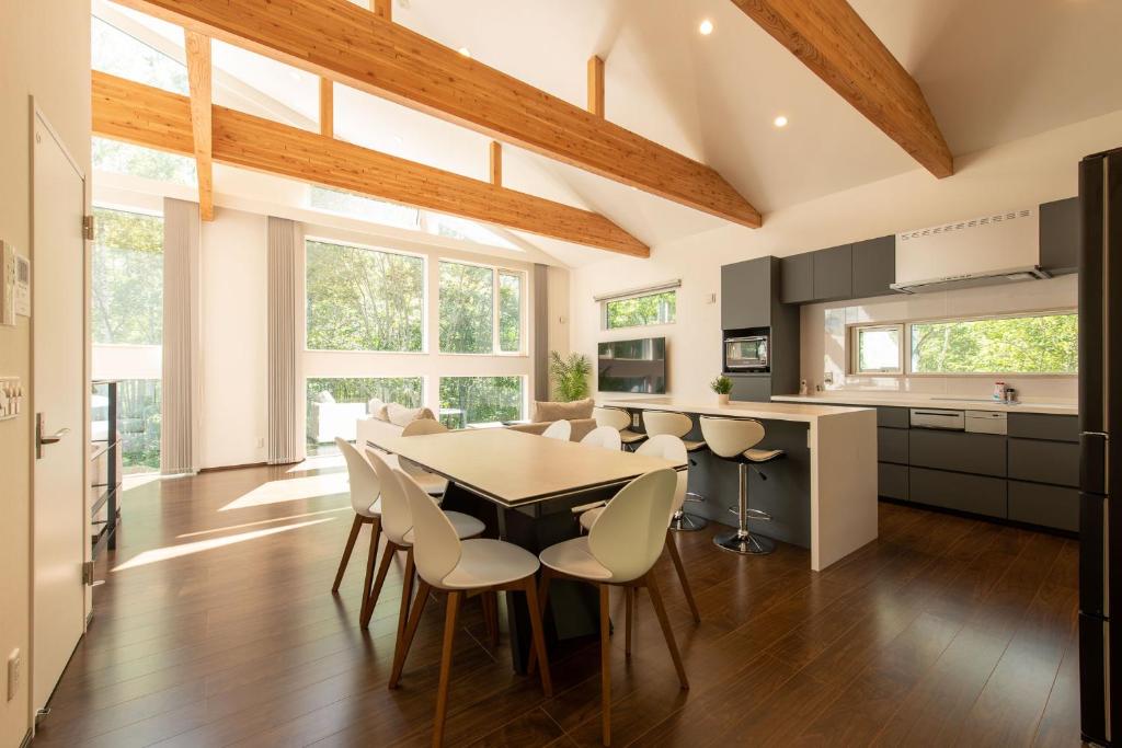 a kitchen and dining room with a table and chairs at Annupuri Onsen Chalet in Niseko