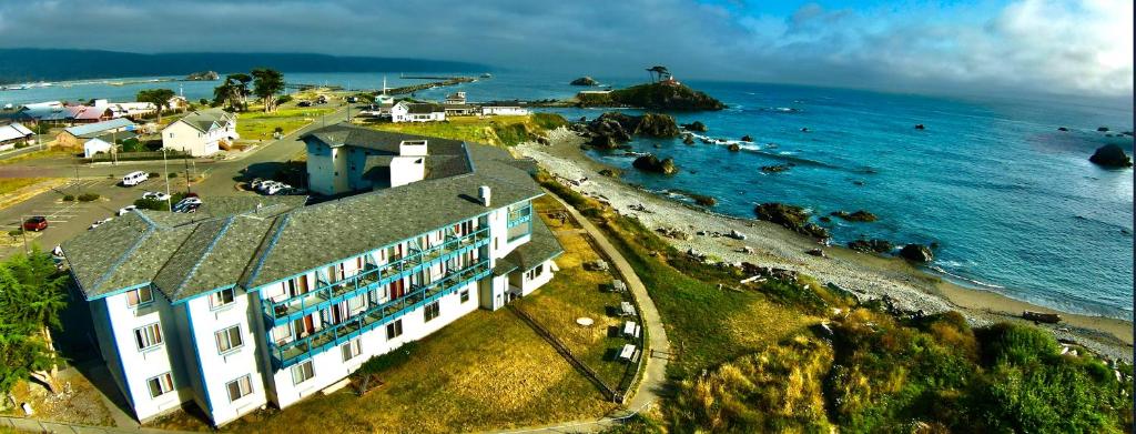 an aerial view of a building on the shore of the ocean at Oceanfront Lodge in Crescent City