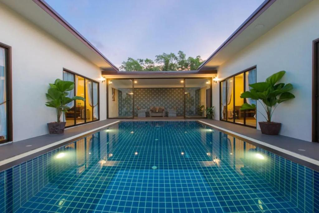 a swimming pool in the middle of a house at The Casita Phuket (SHA+) in Ban Bo Sai Klang