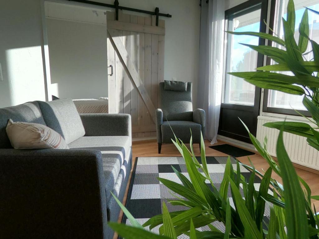 een woonkamer met een bank en een tafel bij Herostreet Apartment 9 in Iisalmi