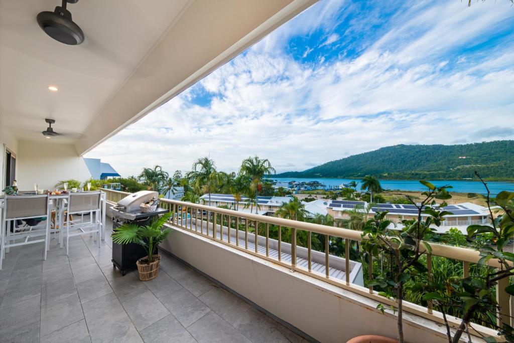 a balcony with a view of the ocean at Eagles Nest On Airlie in Airlie Beach
