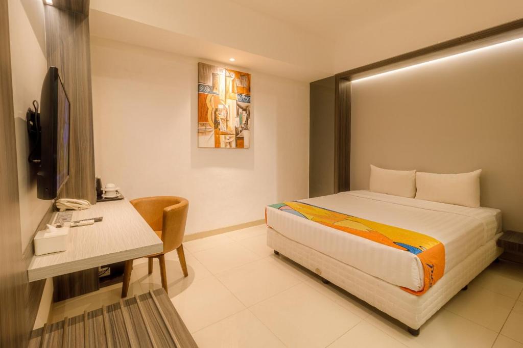 Postel nebo postele na pokoji v ubytování Grand Picasso Hotel