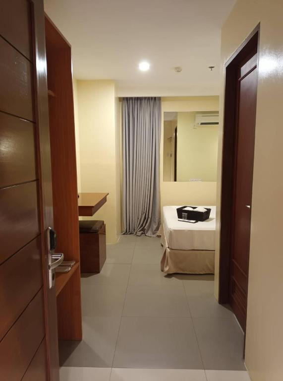 Postel nebo postele na pokoji v ubytování Dosi Hotel PH