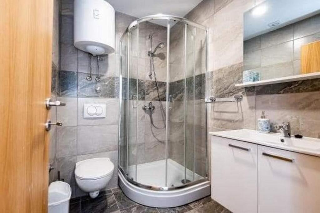 ein Bad mit einer Dusche, einem WC und einem Waschbecken in der Unterkunft Apartments by the sea Gradac, Makarska - 18877 in Gradac