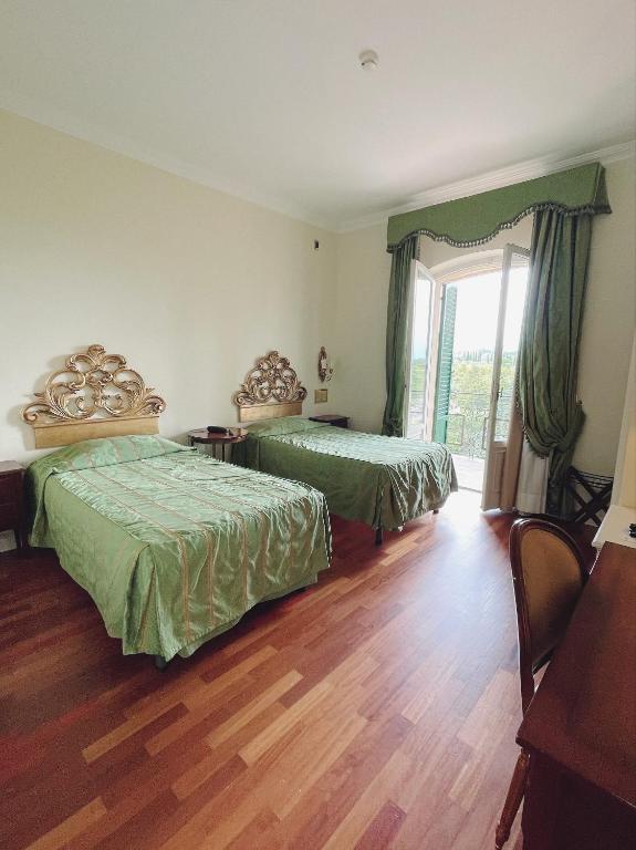 Posteľ alebo postele v izbe v ubytovaní Hotel Villa Il Patriarca