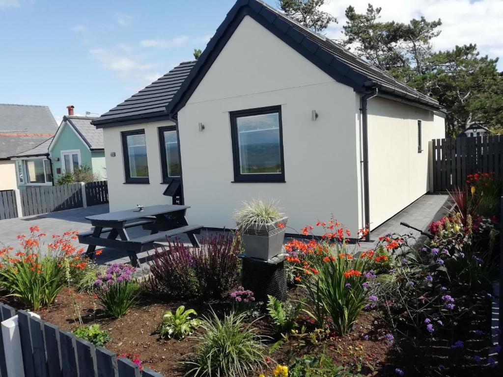 a cottage with a picnic table in a garden at Solway View in Wigton